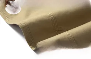 Close-up of khaki cotton shorts showing premium stitching and breathable fabric texture