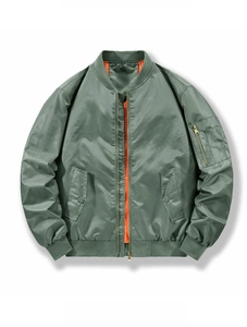 Close-up of MA-1 bomber jacket featuring vibrant orange lining and sleeve utility pocket