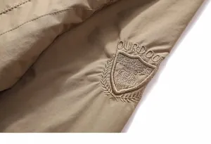 Detail of premium khaki tactical jacket featuring high-density embroidery and windproof fabric