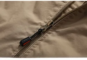 Detail of khaki tactical jacket metal zipper with Sports engraved puller cord
