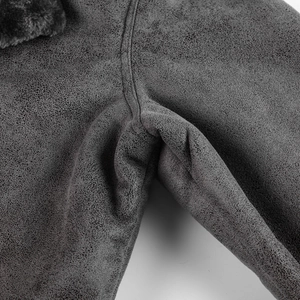 Detail of charcoal faux suede jacket featuring precision double-stitch seams and faux fur trim