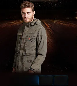 Detail of army green outdoor windbreaker showing hood and ROUGH STOCK graphic print