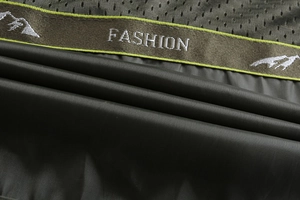 Detail of army green jacket showing breathable mesh lining and fashion brand webbing