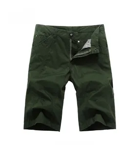Detail of dark green cotton cargo shorts showing metal zipper fly and button closure