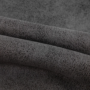 Macro shot of dark grey faux suede fabric texture with refined matte grain finish