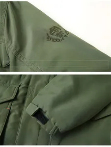 Detail view of the embroidered sleeve patch and adjustable velcro cuffs on army green jacket