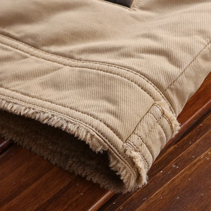 Detail of khaki jacket showing durable twill canvas fabric and warm sherpa fleece lining