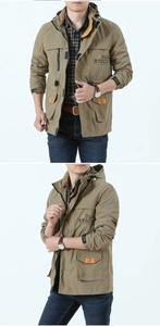 Detail view of khaki hooded outdoor jacket with orange lining and multi-pocket design