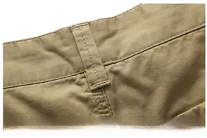 Detailed macro view of khaki cotton shorts belt loops with reinforced neat stitching
