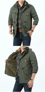 Detail of olive green tactical jacket featuring breathable mesh lining and rough stock print