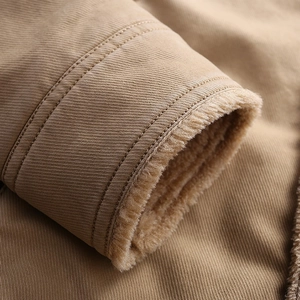 Detailed close-up of khaki jacket cuff featuring warm sherpa lining and reinforced stitching