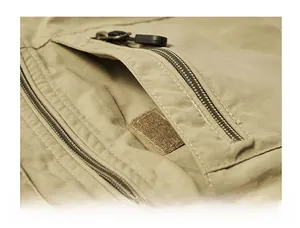 Detailed macro view of khaki tactical vest featuring zipper pocket and velcro fastener