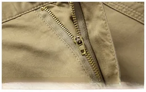 Detailed macro view of high-quality copper metal zipper on cotton twill cargo shorts
