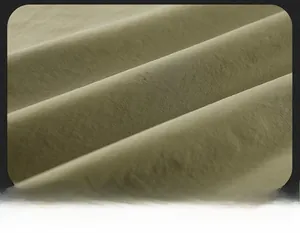 Vue macro détaillée de la texture du tissu respirant vert olive du gilet cargo