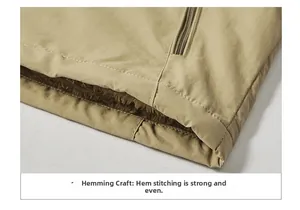 Detail shot of the hem showing reinforced stitching and brown fleece lining on khaki vest