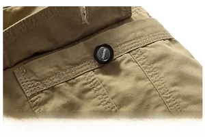 Macro shot of khaki cargo shorts showing reinforced stitching and a jeans logo button