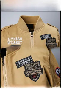 Close-up of khaki flight jacket featuring embroidered badges and retro pilot style patches
