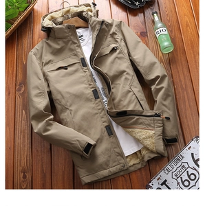 Detailed view of khaki outdoor hooded jacket featuring thick white faux lamb wool lining