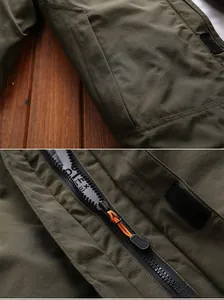 Detail of waterproof zipper with orange puller and velcro strap on outdoor jacket