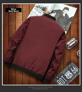 Rear view of burgundy bomber jacket with ribbed collar and cuffs on wood background