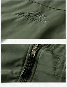 Detail of mountain embroidery and durable bronze metal zipper on green outdoor fleece vest