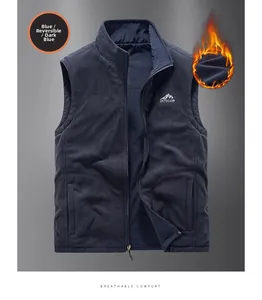 Detail of reversible dark blue fleece vest with stand collar and outdoor mountain logo