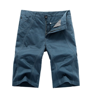 Men's loose cotton cargo shorts in deep teal featuring classic button and zip fly closure