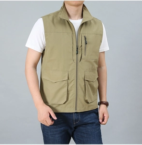 Detail of khaki outdoor vest showing functional utility pockets and zip closure