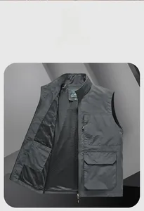 Detail view of deep gray functional utility vest with breathable mesh lining and zipper pocket
