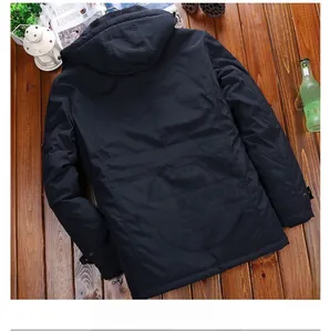 Detail view of a men's navy hooded jacket with warm grey fleece lining on wooden floor