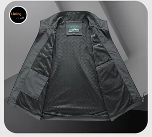 Detail of breathable black mesh lining and functional inner pocket on grey outdoor vest
