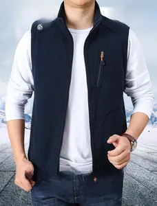 Detail of navy fleece vest showing stand collar and zippered chest pocket for men