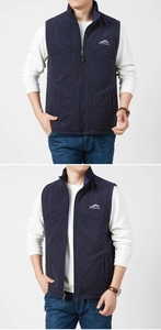 Detail of navy blue fleece vest with embroidered mountain logo and outdoor zip standing collar