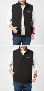 Detail of black fleece vest featuring high neck zipper and outdoor chest logo embroidery