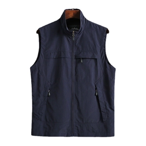 Detail of navy blue standing collar vest featuring metal zippers and chest pocket design