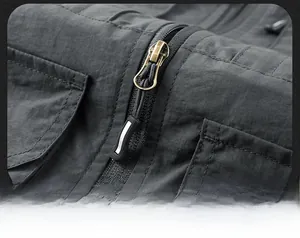 Close-up of durable metal zipper and ripstop fabric on a men's outdoor utility vest