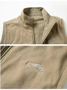 Detail of khaki outdoor fleece vest showing reversible fabric texture and logo embroidery