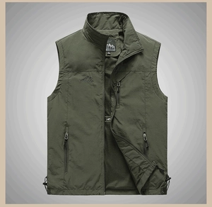 Detail of army green outdoor vest with zipper pockets, mesh lining and embroidery