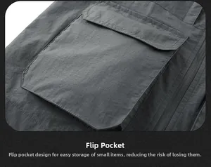 Detail of dark grey cargo vest featuring a flap pocket and durable woven texture