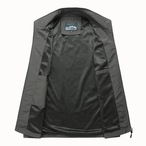 Detail of grey outdoor vest showing breathable black mesh lining and stand collar