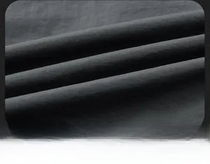 Macro shot of dark grey cotton blend fabric texture showing detailed fiber weave