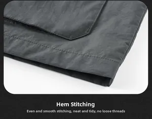 Detail view of double-stitched hem on dark gray fishing vest with durable sewing crafts