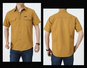 Dettaglio camicia da lavoro in cotone giallo senape a maniche corte con taschini