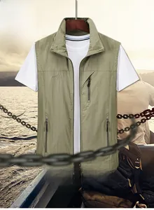 Close-up of military green outdoor fishing vest with multiple zipper pockets and embroidery