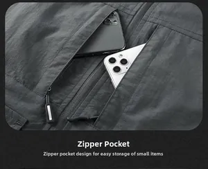 Close-up of deep dual zippered pockets on a men's outdoor vest showing storage capacity