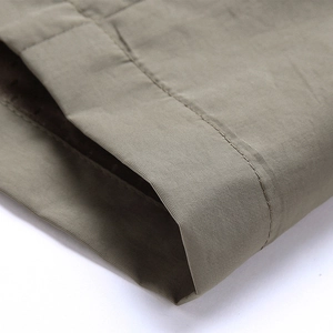 Detail of army green outdoor vest showing high-quality fabric texture and neat stitching