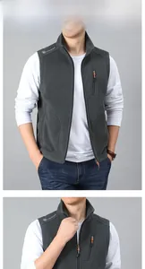 Detail view of dark grey fleece vest showing stand collar and zippered chest pocket