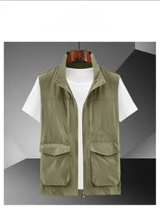 Detail of khaki outdoor vest showing stand collar, zip closure and large utility pockets