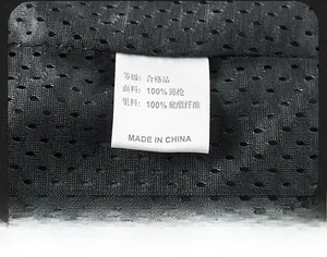 Detail view of the durable nylon mesh fabric and product wash label on utility vest