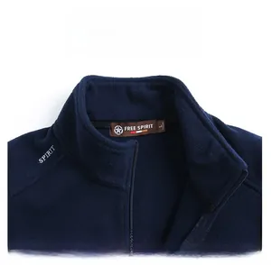 Detail view of the embroidered logo and inner neck label on dark blue fleece vest